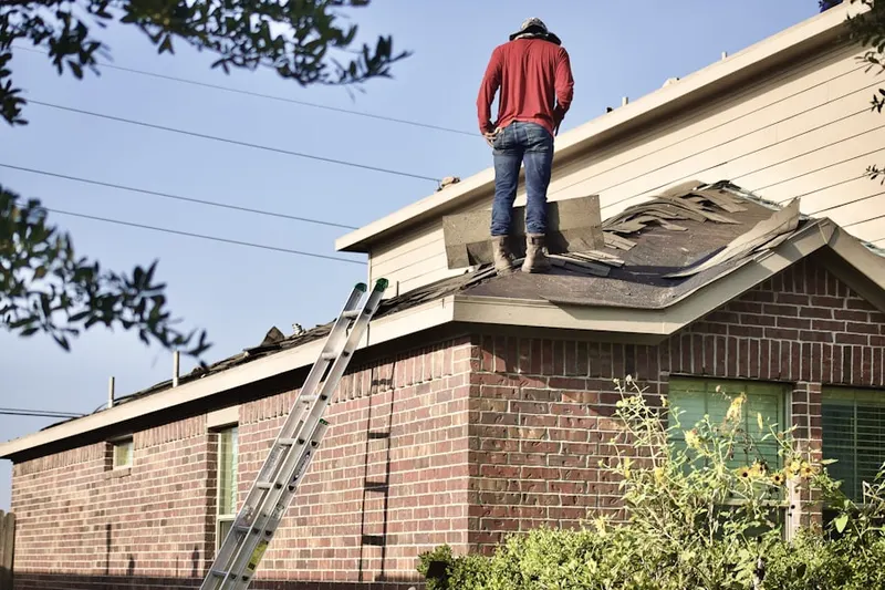 Professional roofer working on a residential roof in Joshua